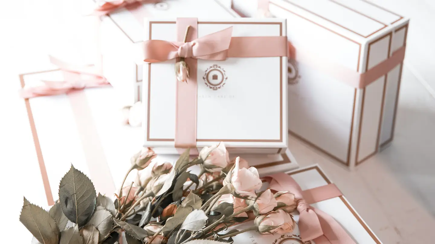 Pink ribbon gift boxes arranged with dried roses